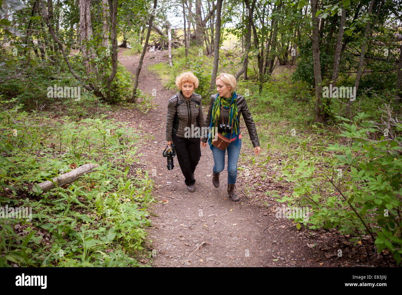 Mother and daughter hiking on path in Alaska Stock Photo