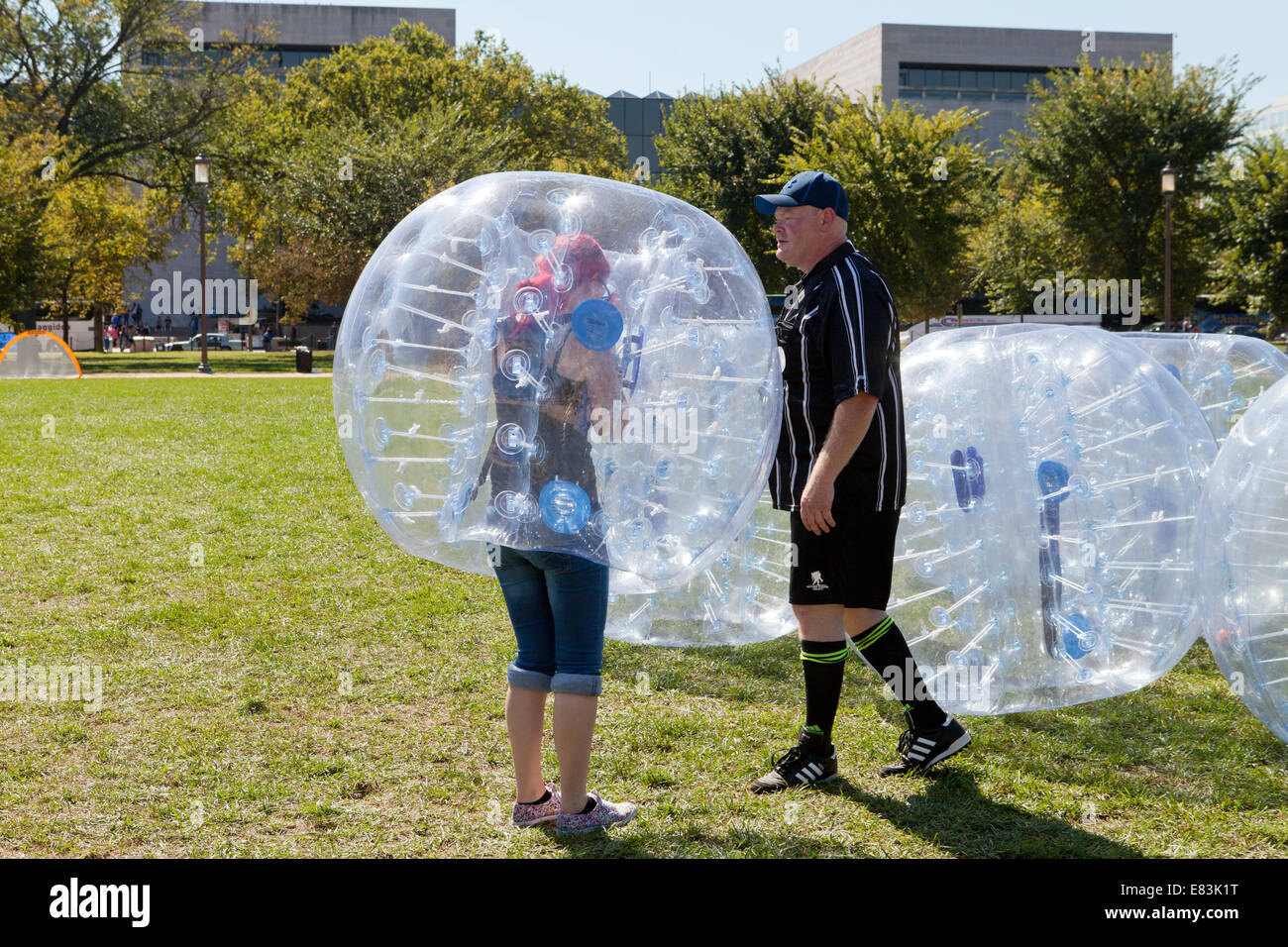 Woman putting on bubble suit USA Stock Photo Alamy