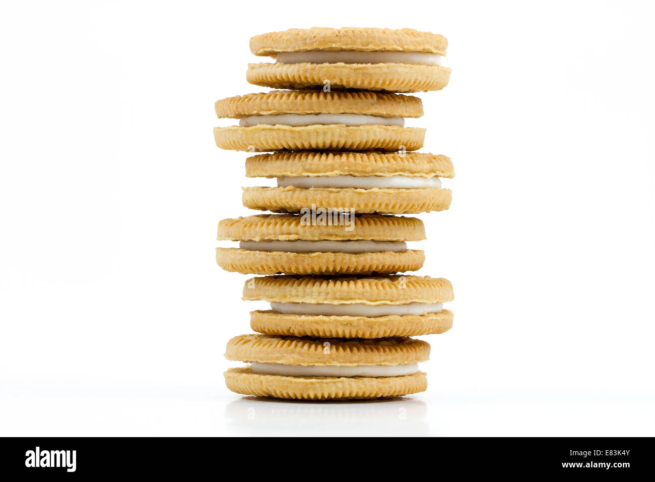 Stack of Vanilla cookies with cream filling on white background Stock Photo