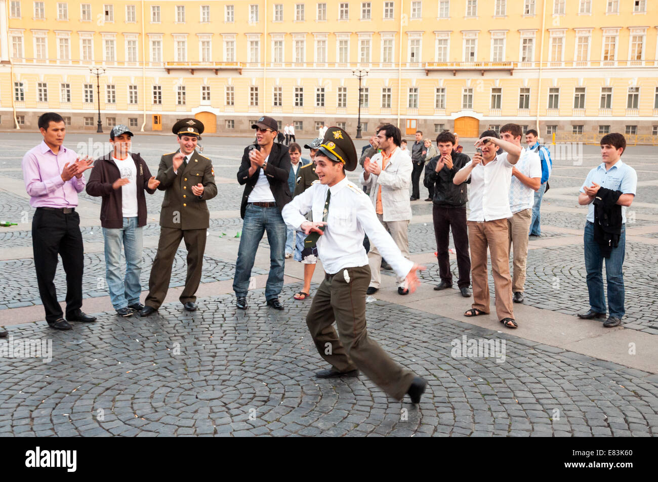 Drunk off duty army officer dancing in Dvortsovaya Ploshchad on one of the White Nights, St Petersburg, Russia Stock Photo