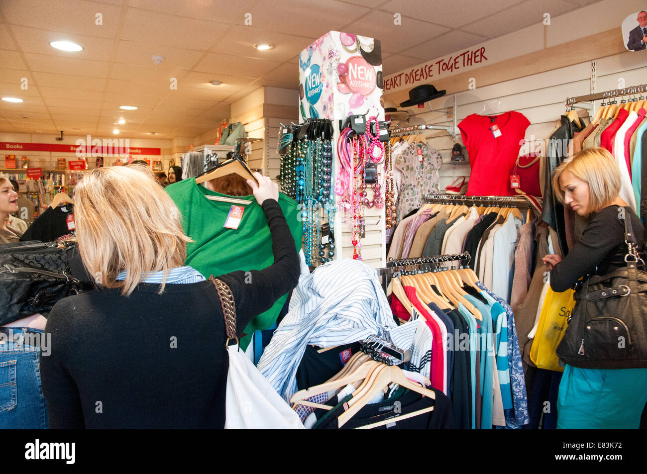 People shopping in Oxfam charity shop, London, England, UK Stock Photo