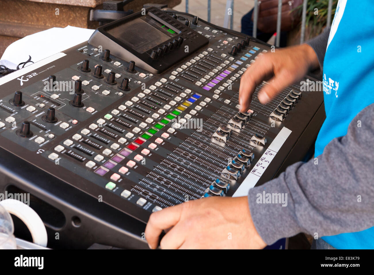 Technician at work on audio mixing console - USA Stock Photo