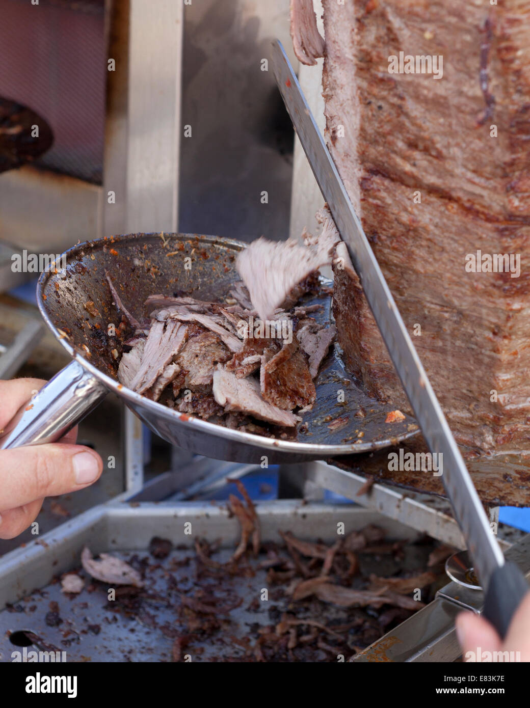 Cook slicing Doner kebab meat - USA Stock Photo