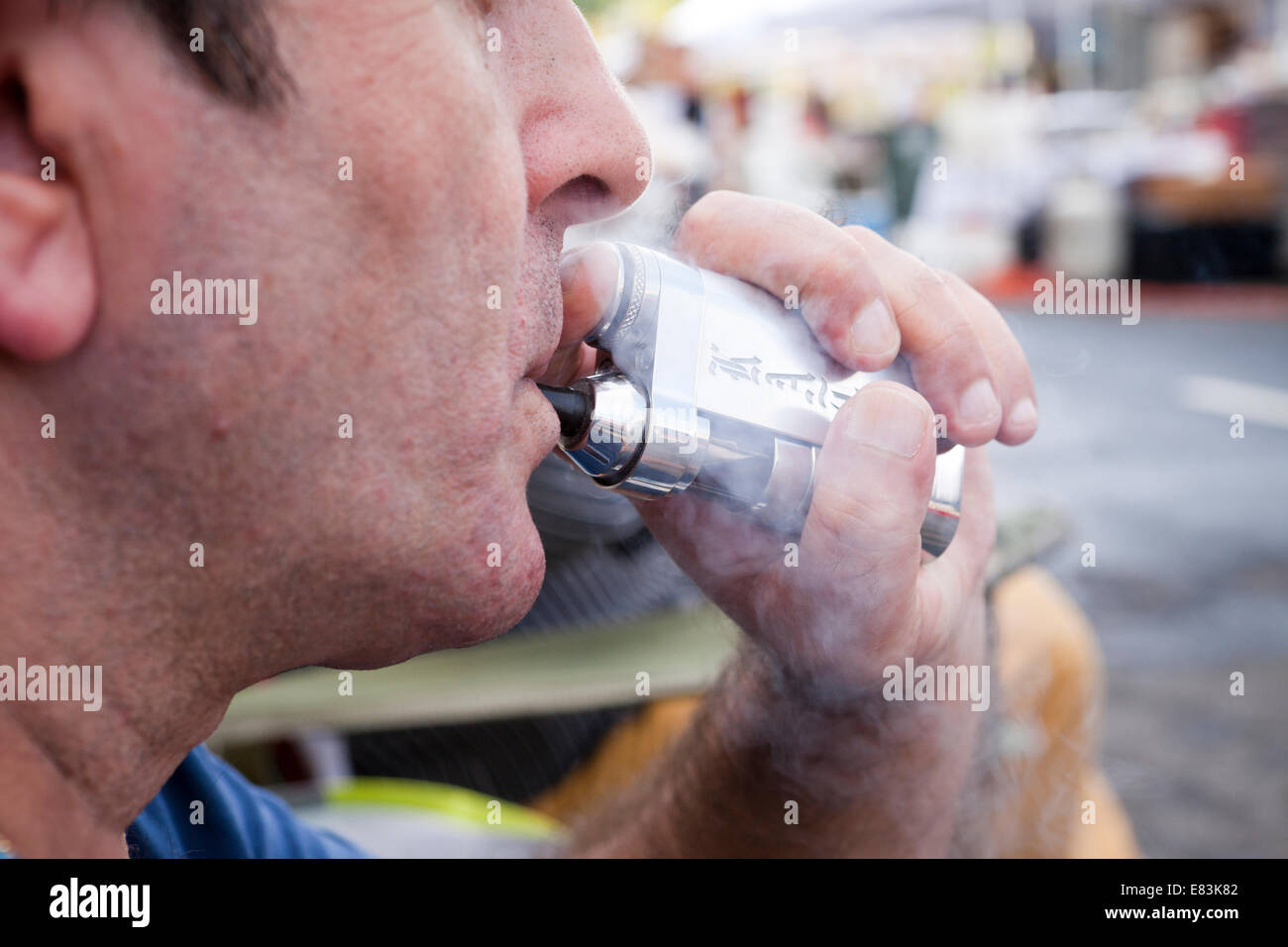Man using portable nicotine vaporizer - USA Stock Photo