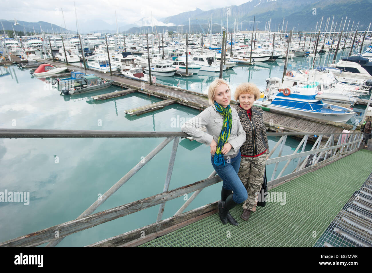 Mother and daughter together in front of marina in Alaska Stock Photo