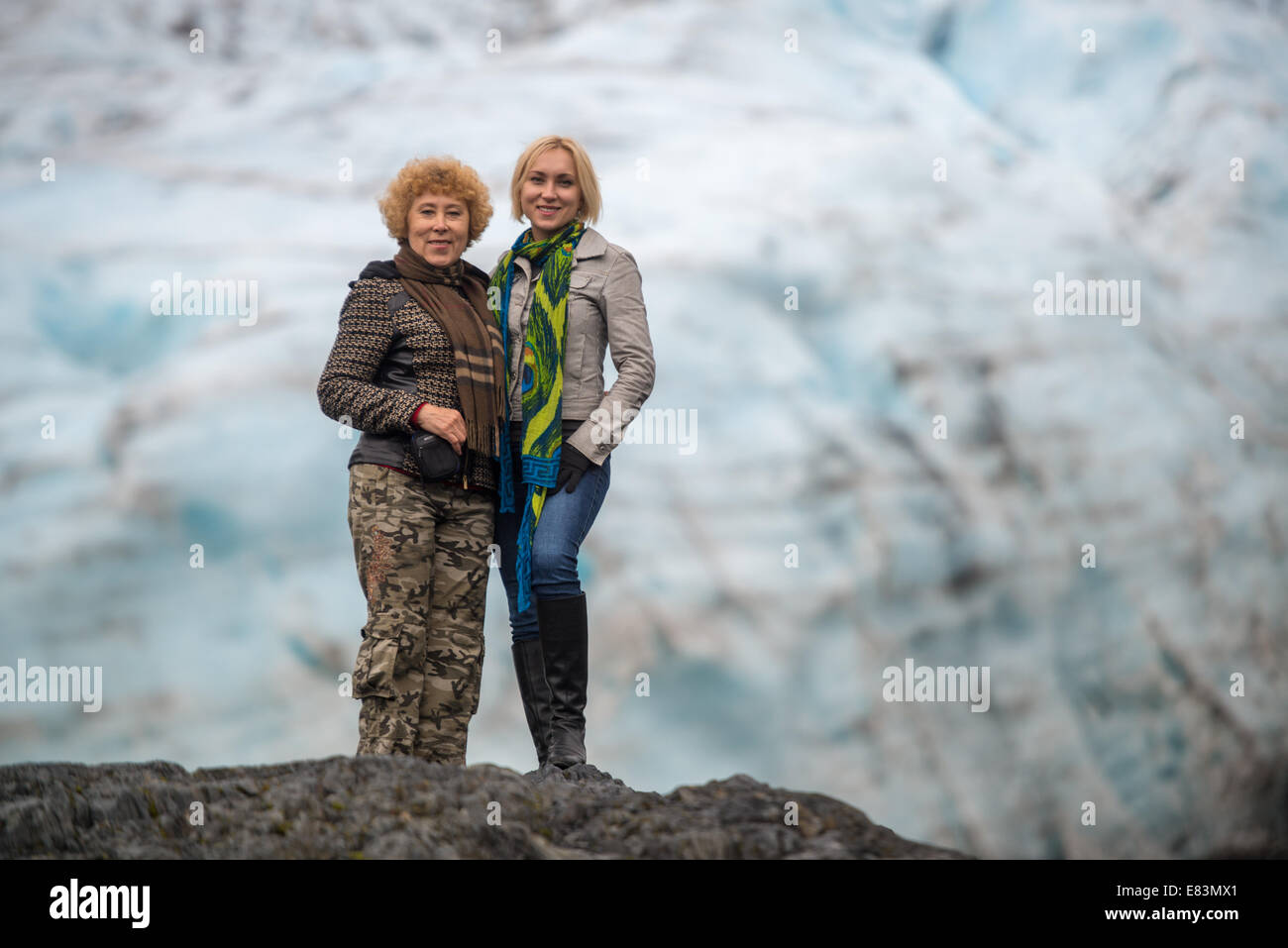 Mother and daughter together in front of glacier in Alaska Stock Photo