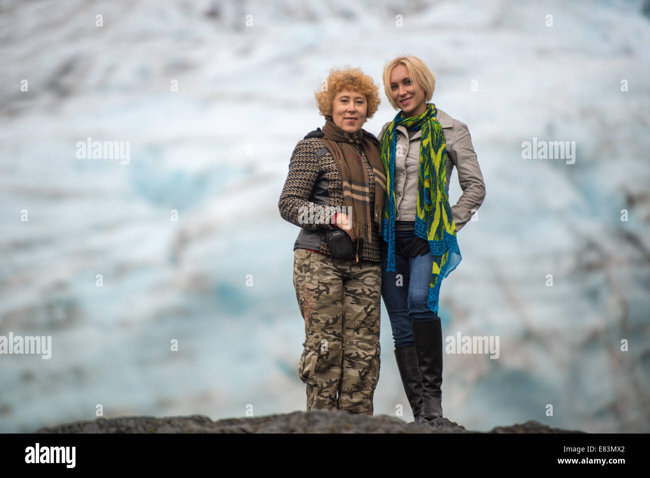 Mother and daughter together in front of glacier in Alaska Stock Photo