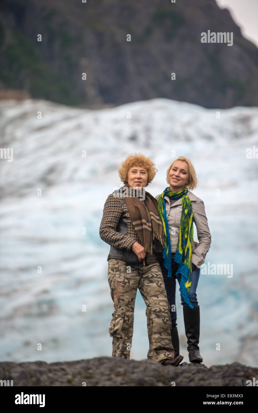 Mother and daughter together in front of glacier in Alaska Stock Photo