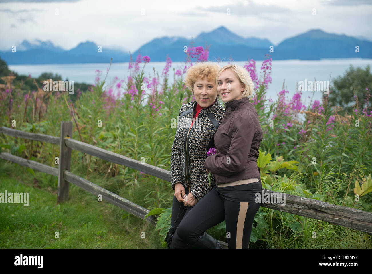 Mother and daughter together in from of fireweed in Alaska Stock Photo