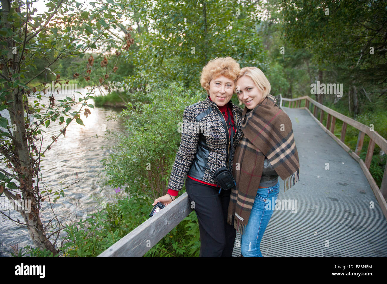 Mother and daughter together along pathway in Alaska Stock Photo