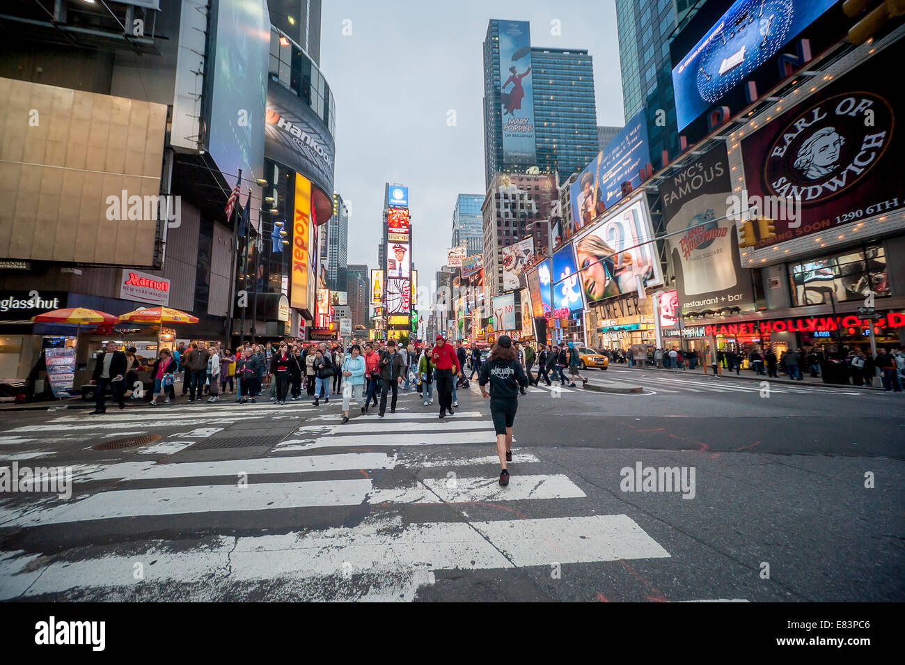Tourists take in the sights and bright lights of Times Square New York City Stock Photo