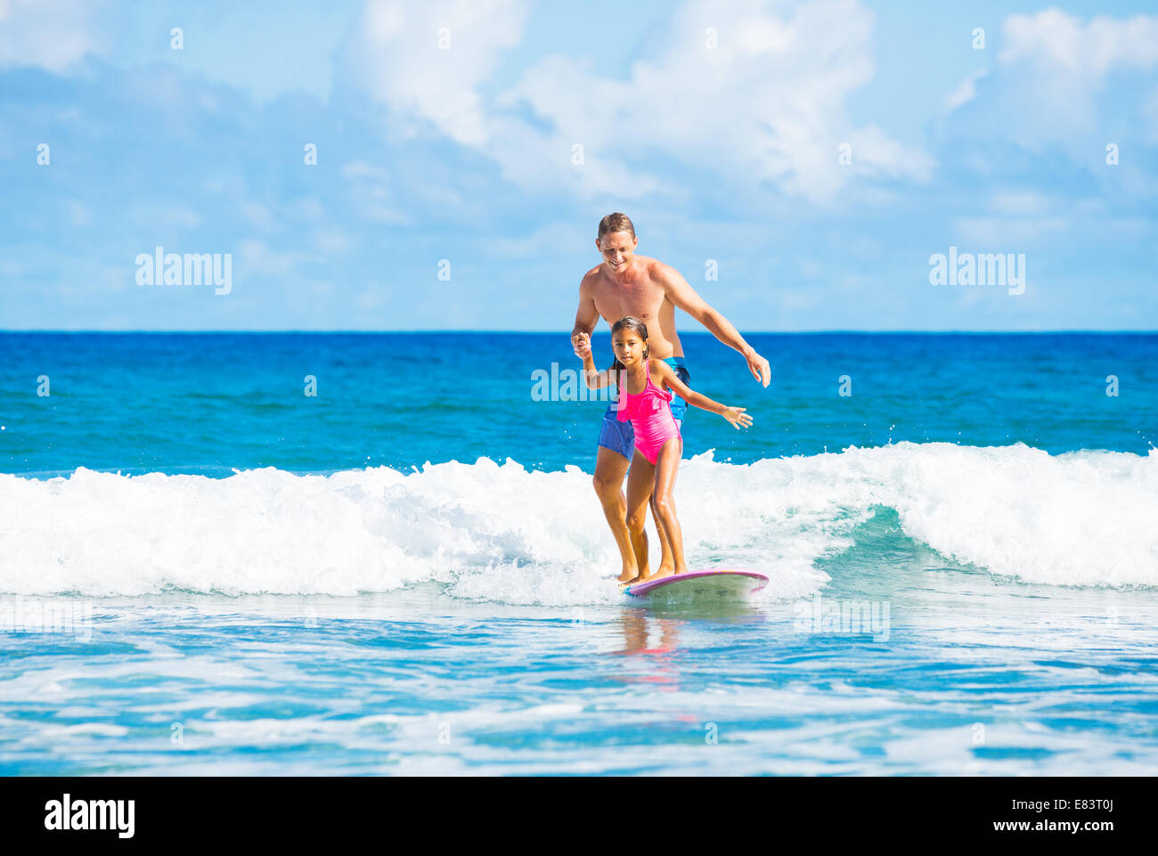 Father and Daughter Surfing Together Catching Wave, Summer Lifestyle Family Concept Stock Photo