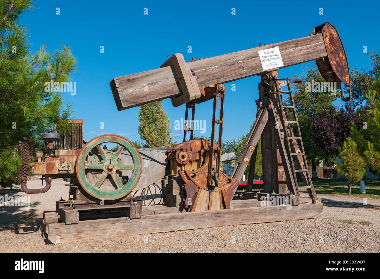 California, Kern County, Maricopa Memorial Park Museum, wooden walking beam oil well pump jack Stock Photo