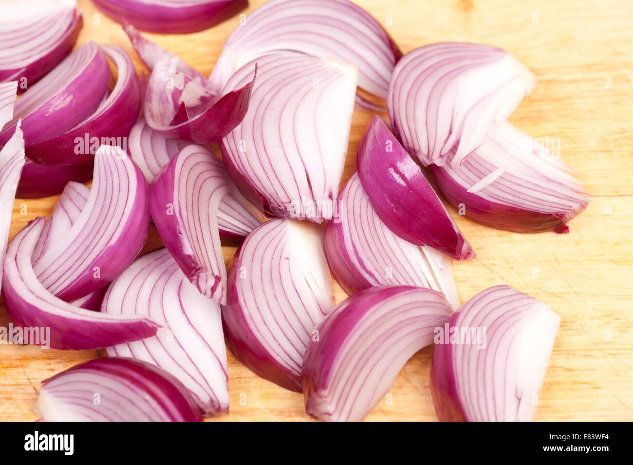 chopped red onions in to wedges on chopping board Stock Photo - Alamy
