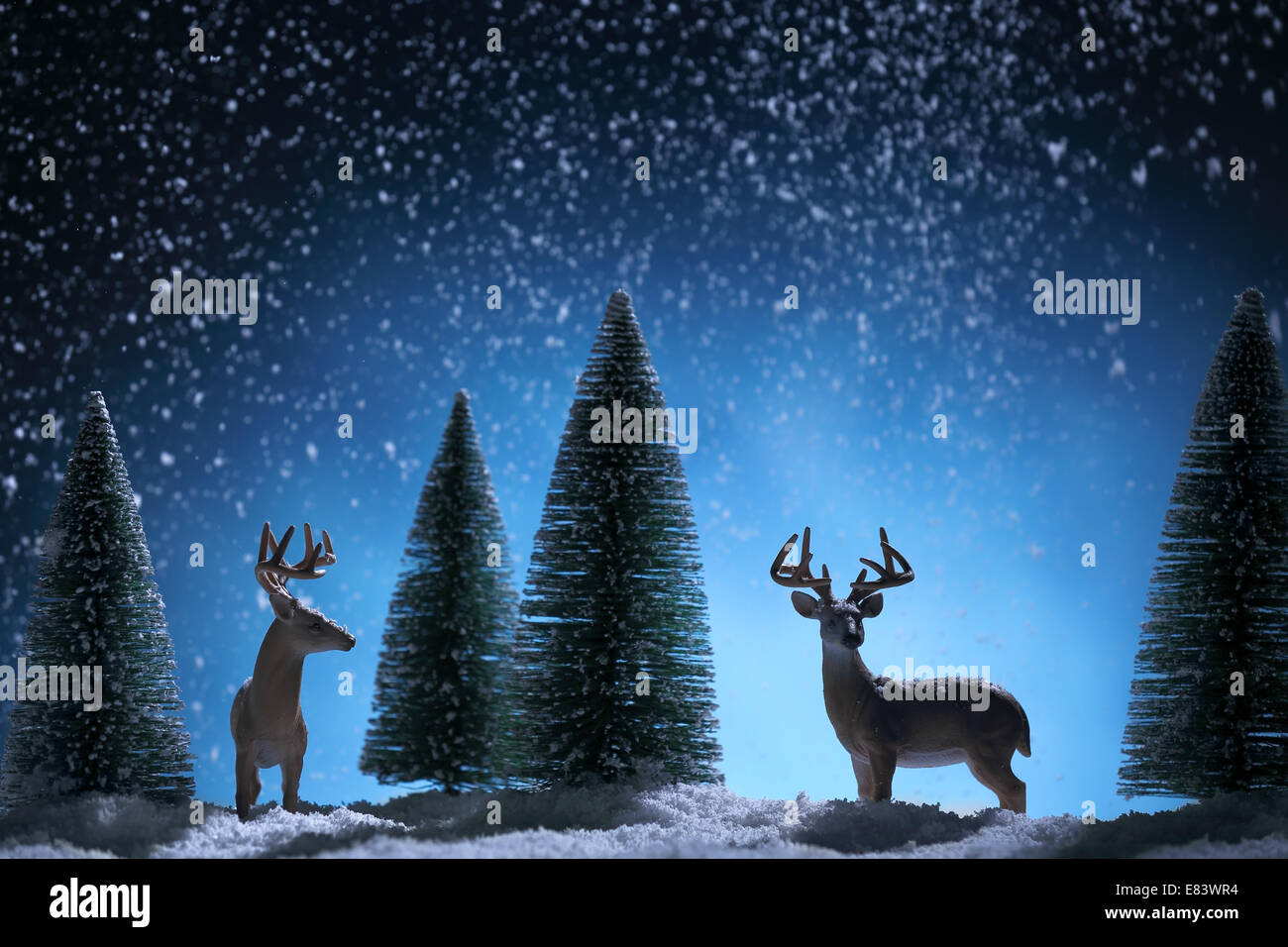 Silhouette of deers and fir tree on Christmas background.Christmas greeting card. Stock Photo