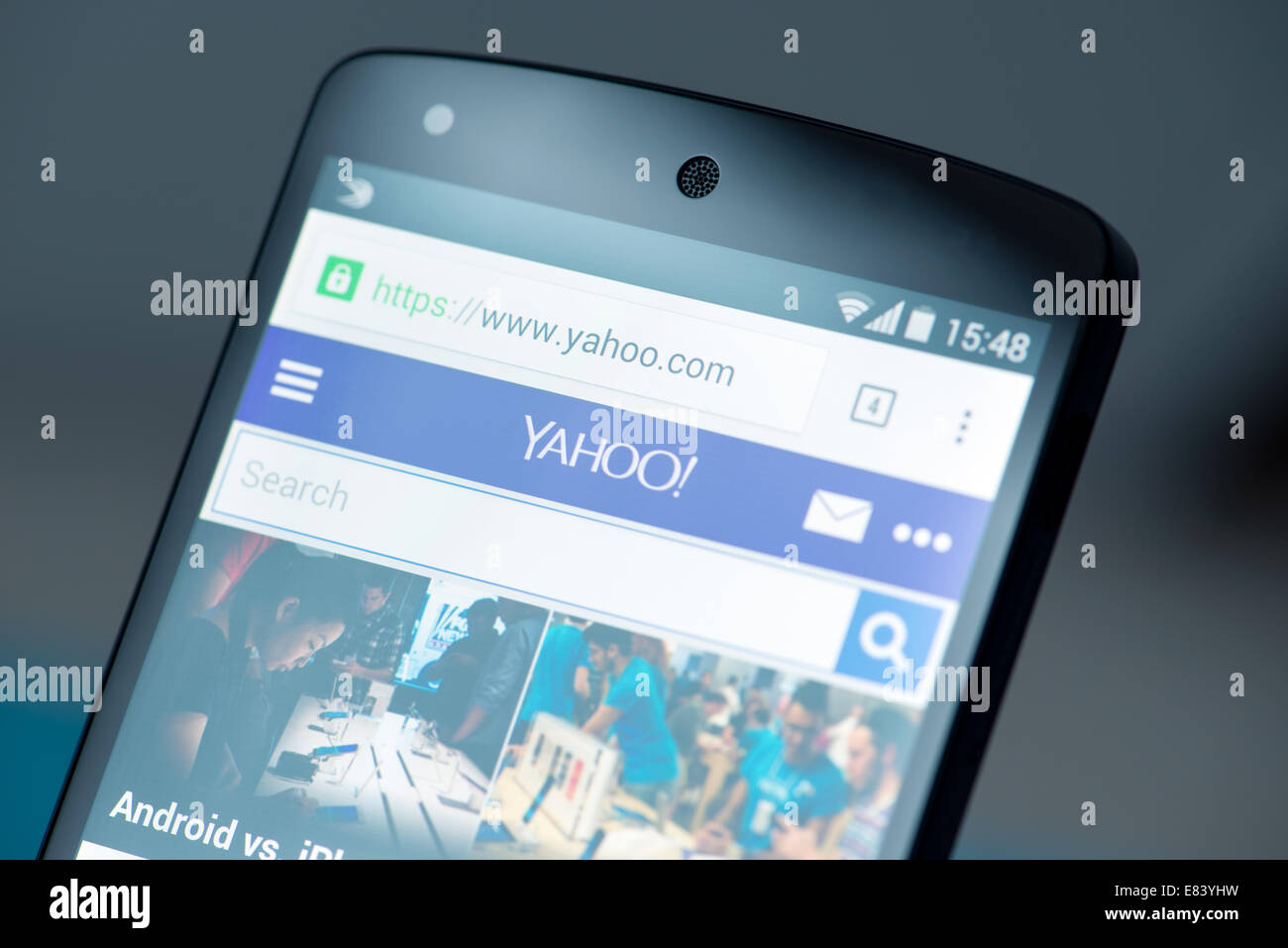 Close-up shot of brand new Google Nexus 5, powered by Android 4.4 version, with Yahoo website news page on a screen. Stock Photo