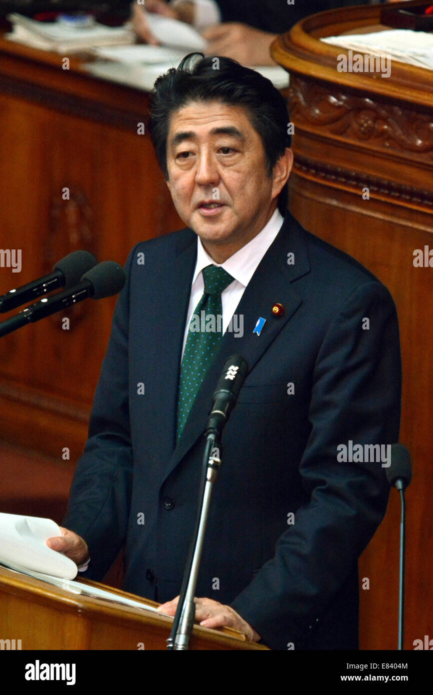 Tokyo, Japan. 30th Sep, 2014. Japan's Prime Minister Shinzo Abe reads prepared statement as he answers to Banri Kaieda of the Democratic Party of Japan during an interpellation at a Diet lower house plenary session in Tokyo on Tuesday, September 30, 3014. The extraordinary Diet session convened Monday for a 63-day run. Credit:  Natsuki Sakai/AFLO/Alamy Live News Stock Photo