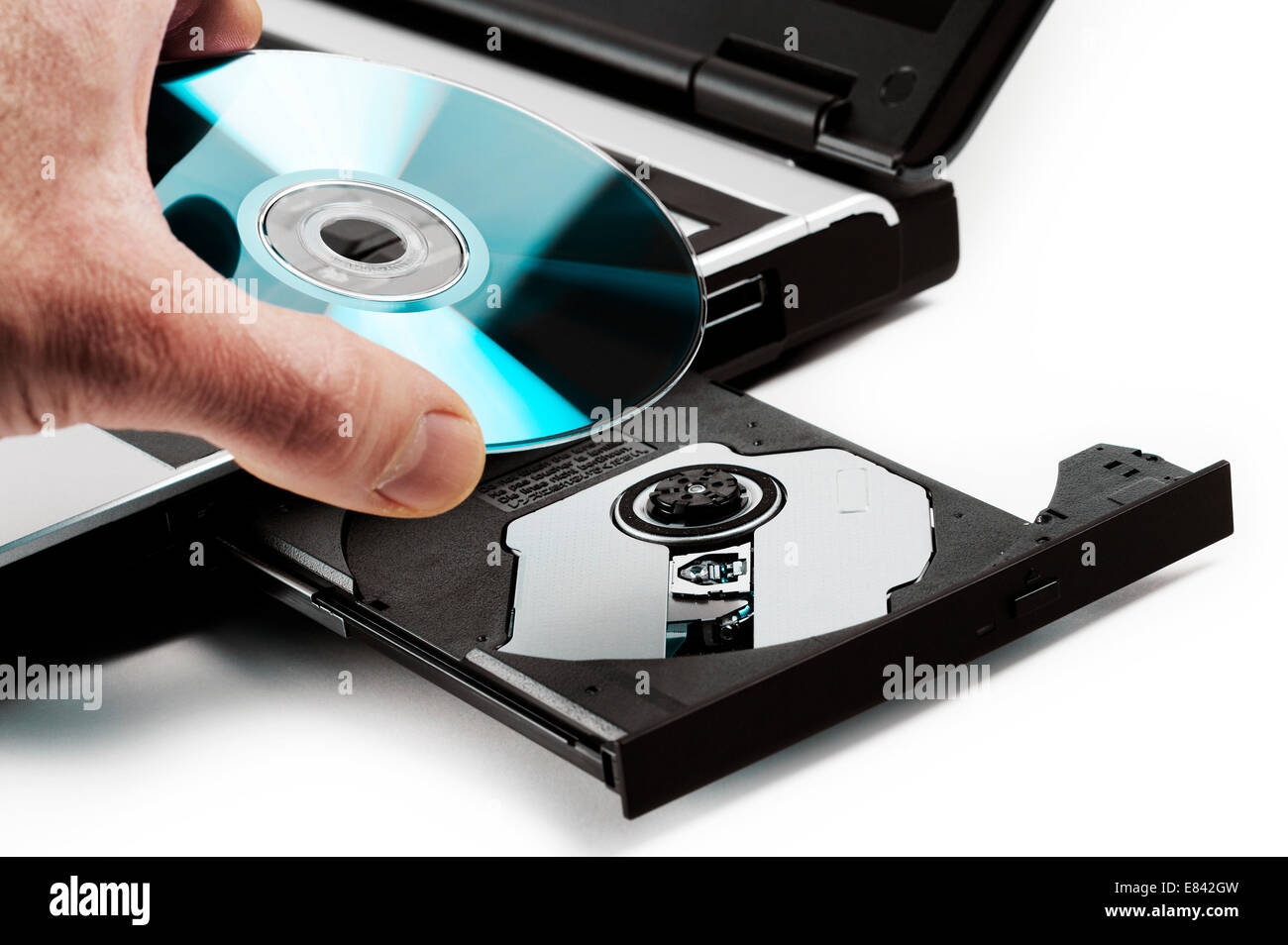 compact disk inserted on notebook drive, on white background Stock Photo