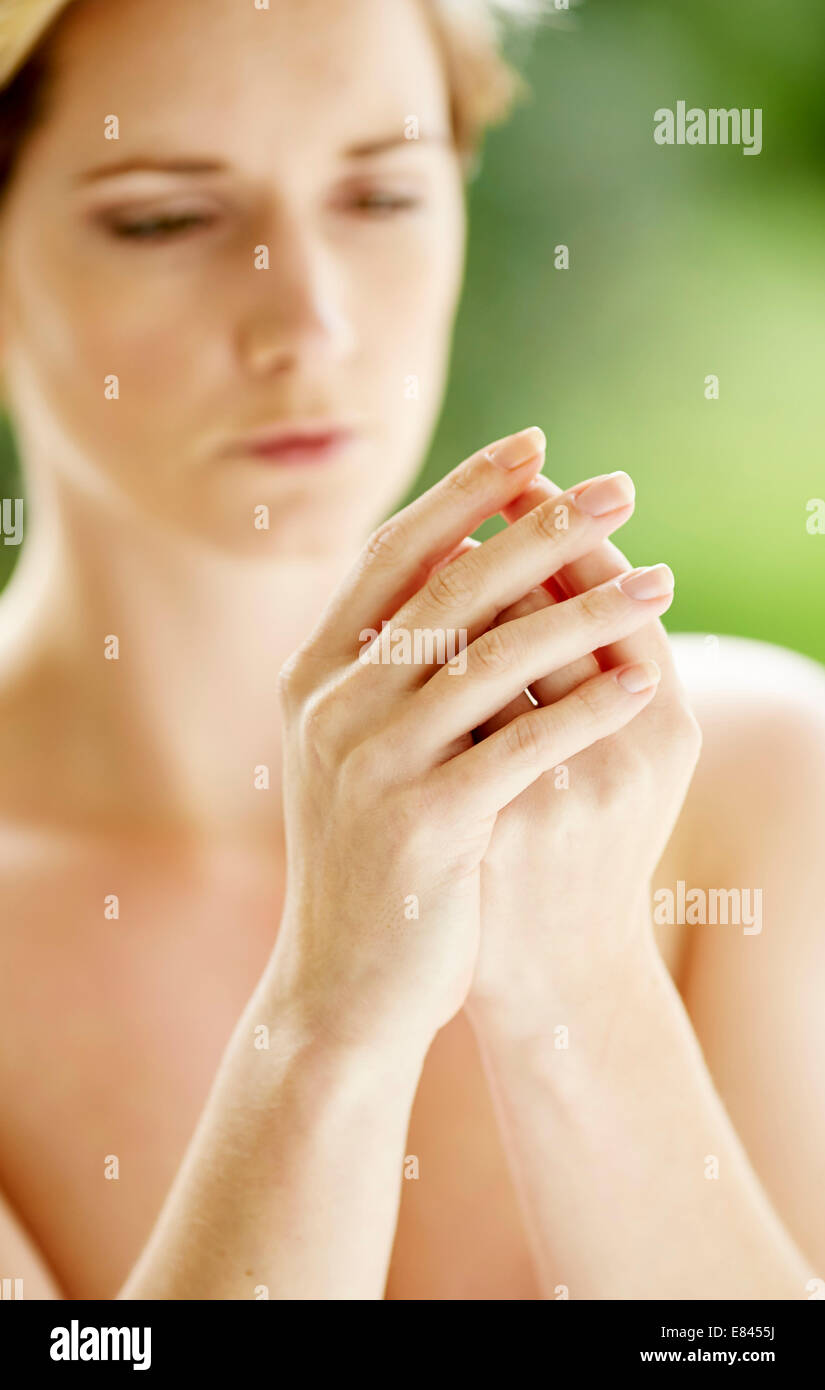 Woman massaging hands Stock Photo