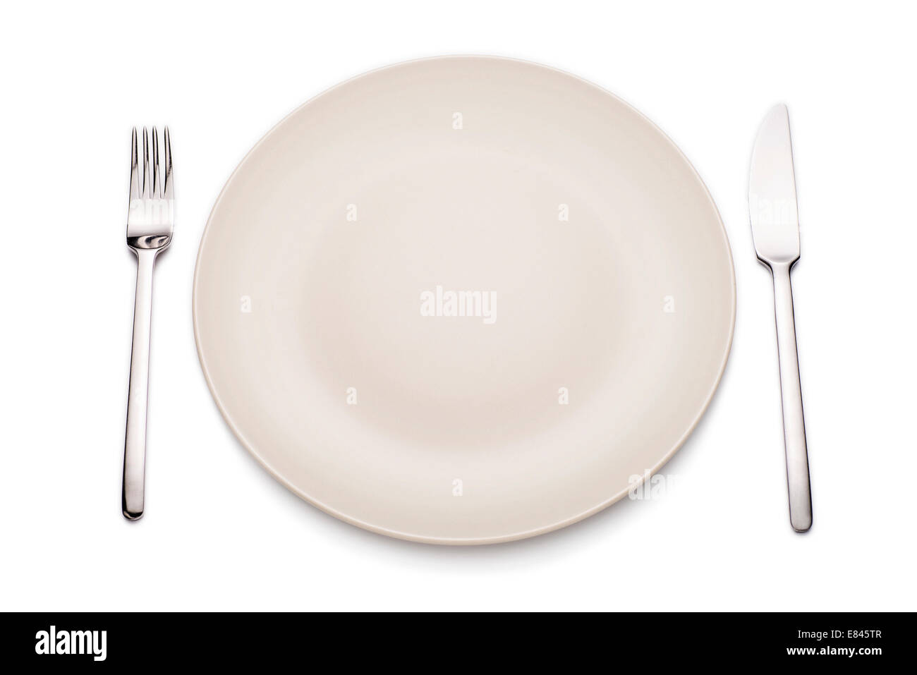 Empty plate with knife and fork Stock Photo