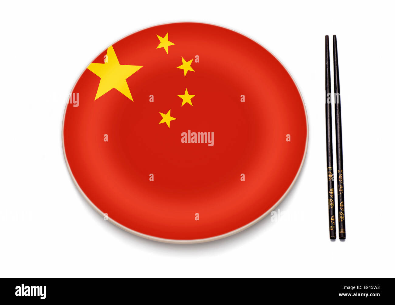 Knife, fork and a plate in the colors of the Chinese flag. Stock Photo