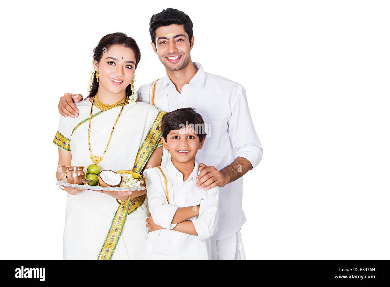 South Indian family standing Worship Stock Photo