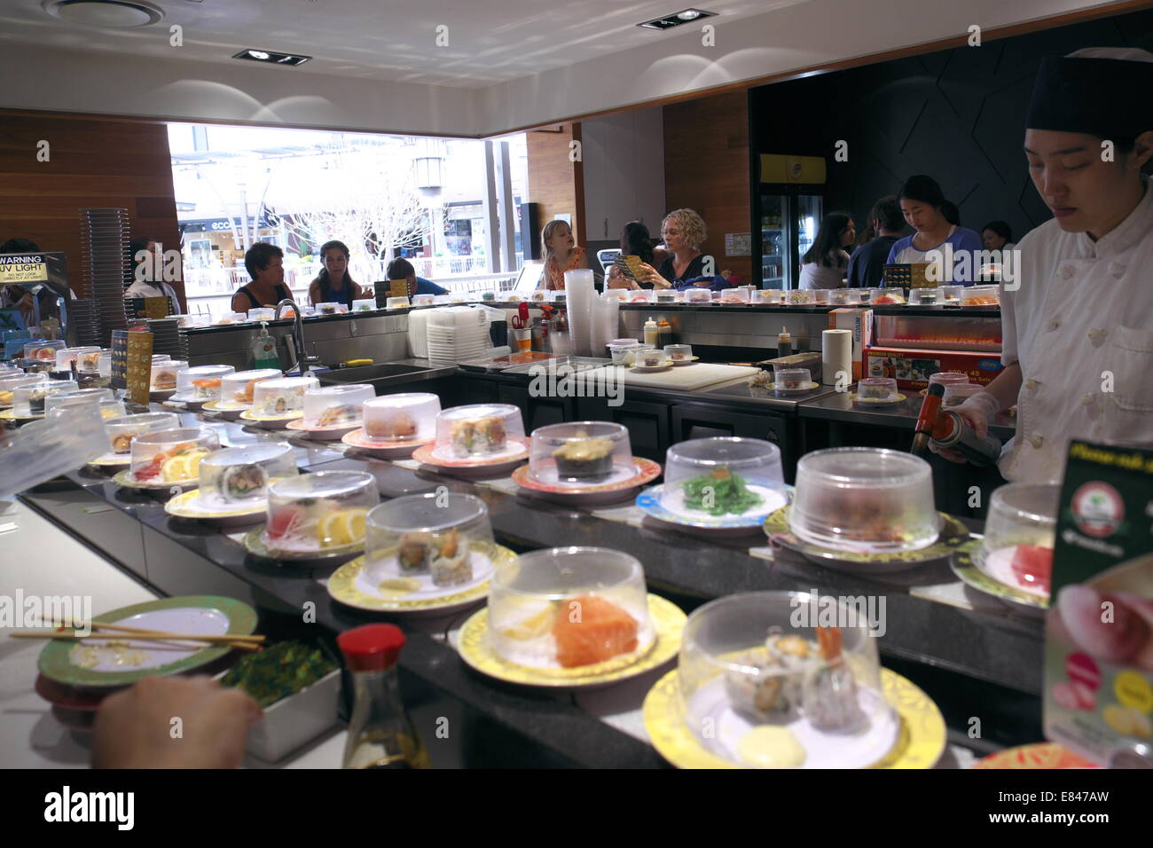 japanese restaurant selling sushi on a train ( revolving belt) in