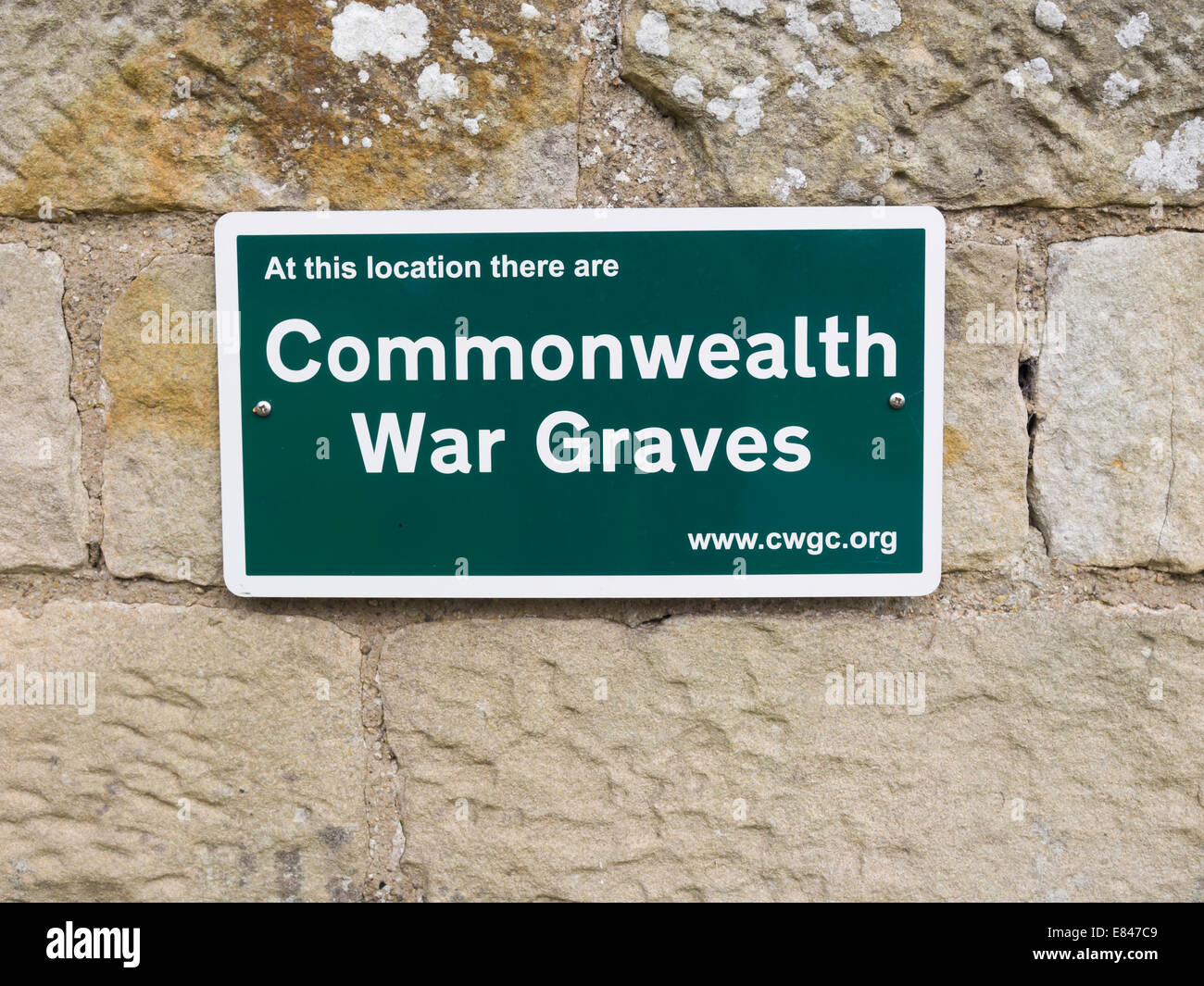 Notice on a church wall: at this location there are Commonwealth War Graves Stock Photo