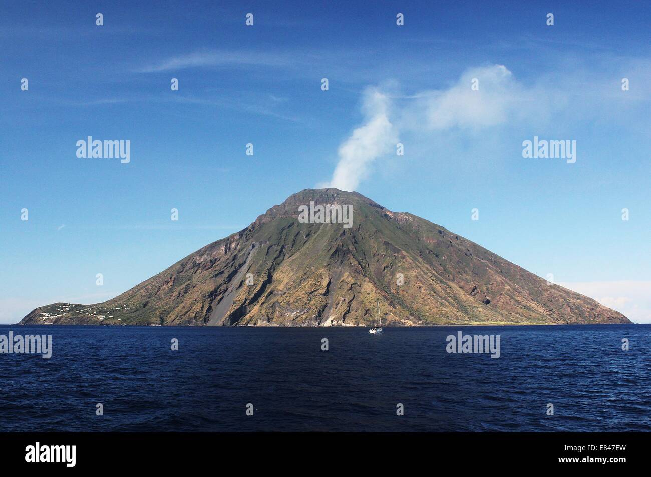 Mount Stromboli off the coast of Sicily with a volcanic plume coming from the top. Stock Photo
