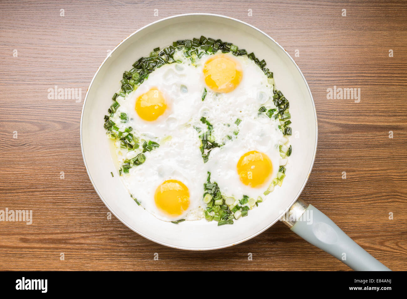 4 four fried egg yolks in frying pan Stock Photo - Alamy