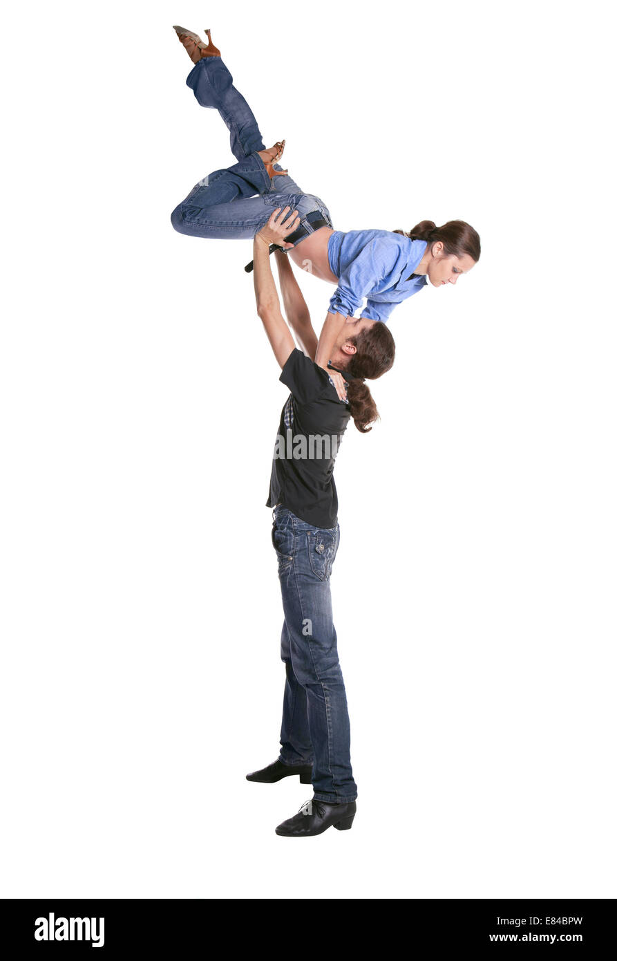 Couple making acrobatic feat isolated over white background Stock Photo