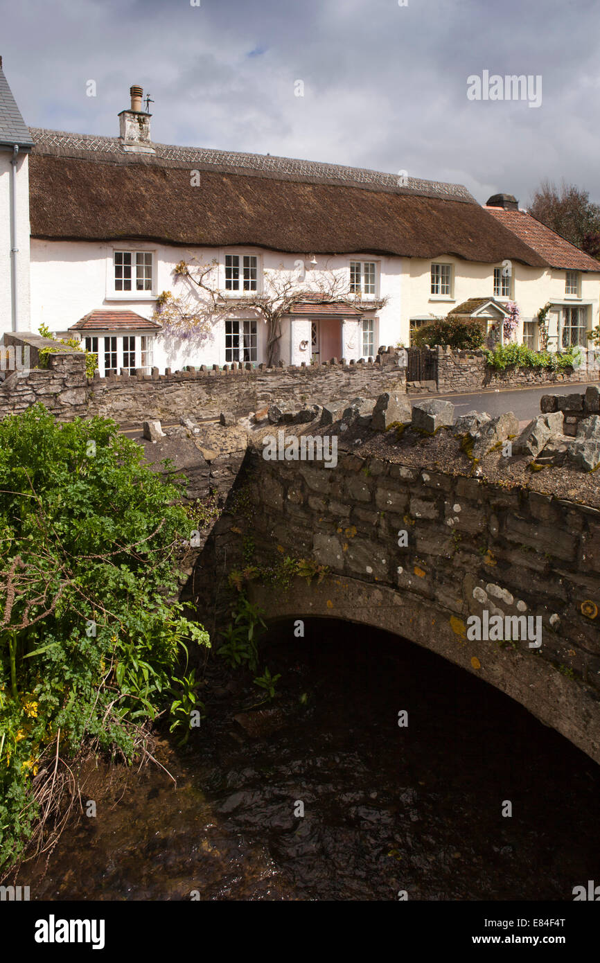 UK, England, Devon, Croyde, thatched cottages beside stream passing through village Stock Photo