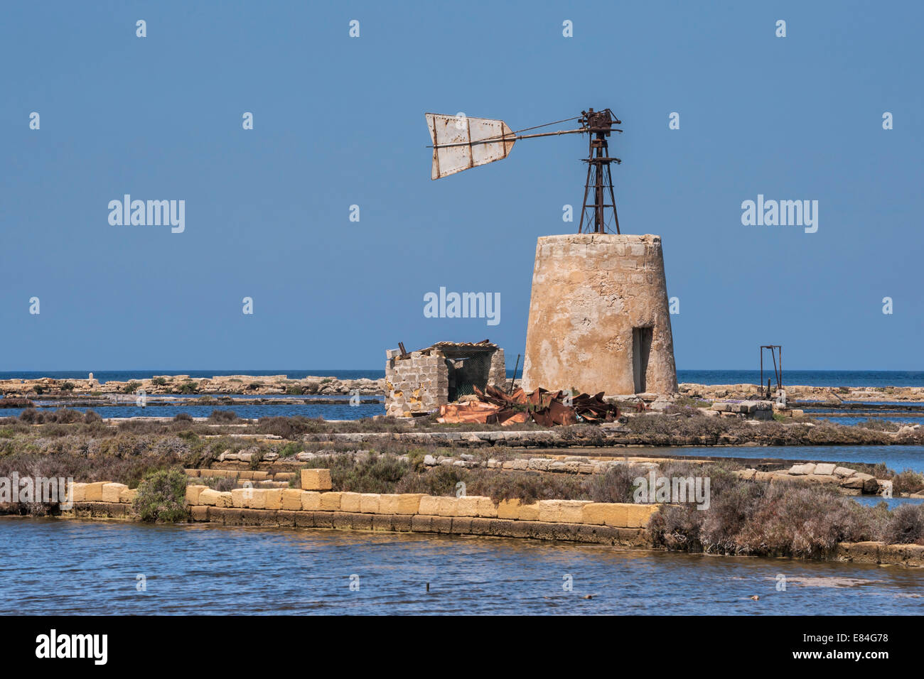 A broken windmill in a saline near Marsala, Paceco, Trapani, Sicily, Italy, Europe Stock Photo