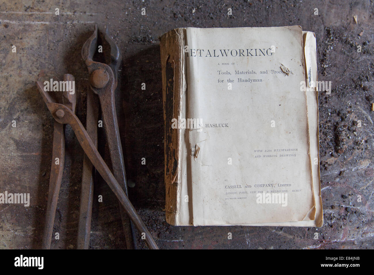 Traditional blacksmith's metalwork book with tools, Moretonhampstead, Dartmoor, Devon Stock Photo