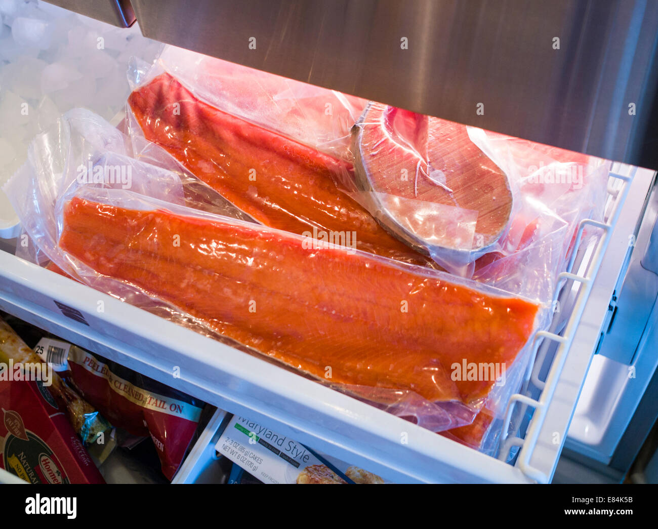 Fresh frozen salmon fish steaks & fillets in kitchen freezer, from