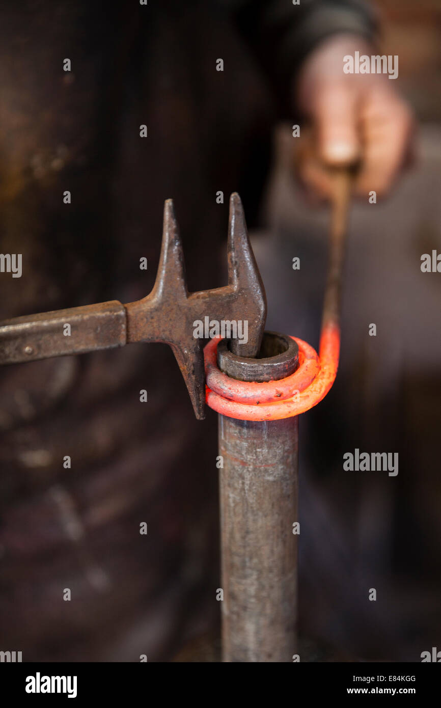 Blacksmith at work in his forge Stock Photo