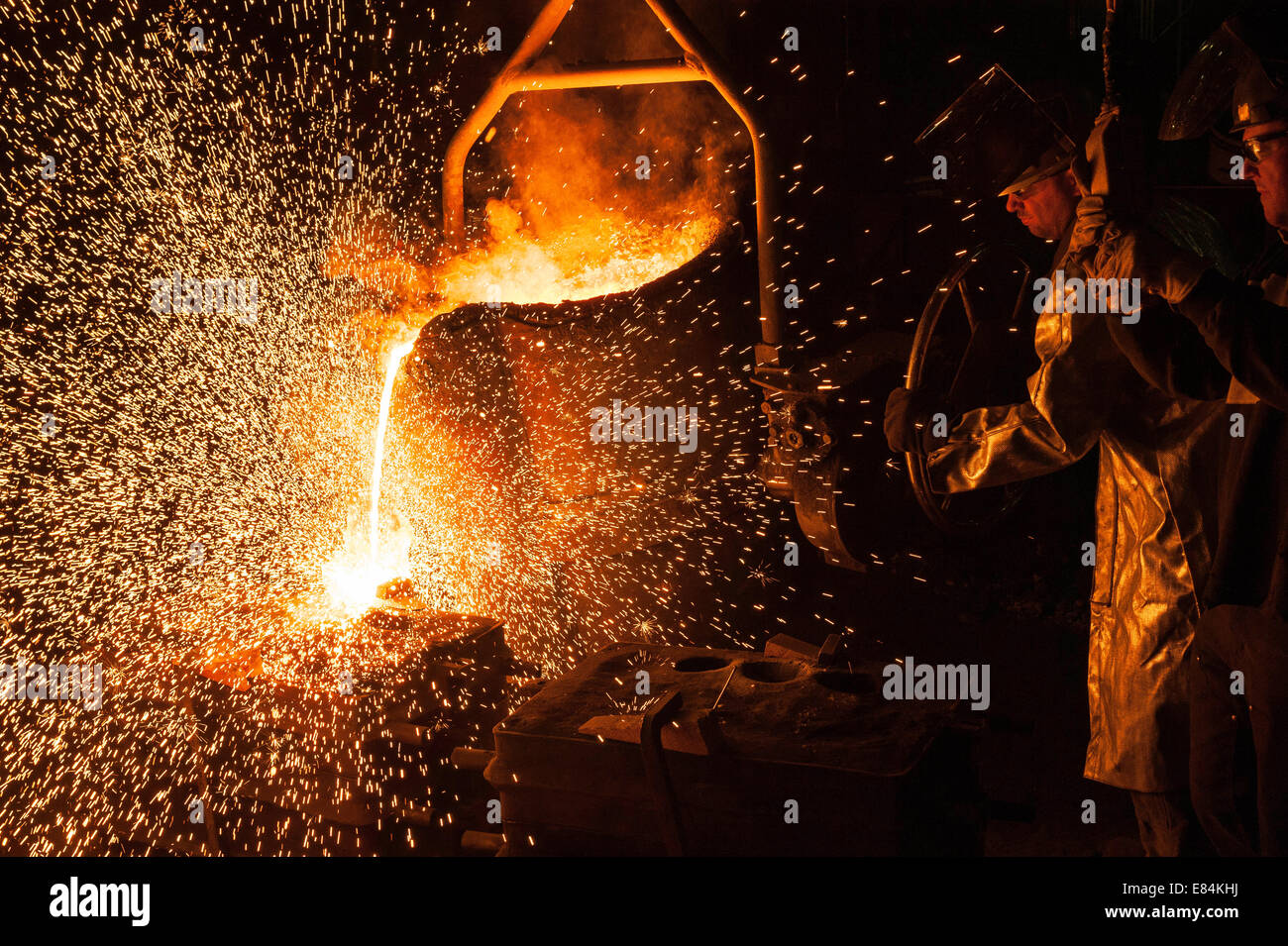 Molten high heat stainless steel is poured into into sand casting molds ...