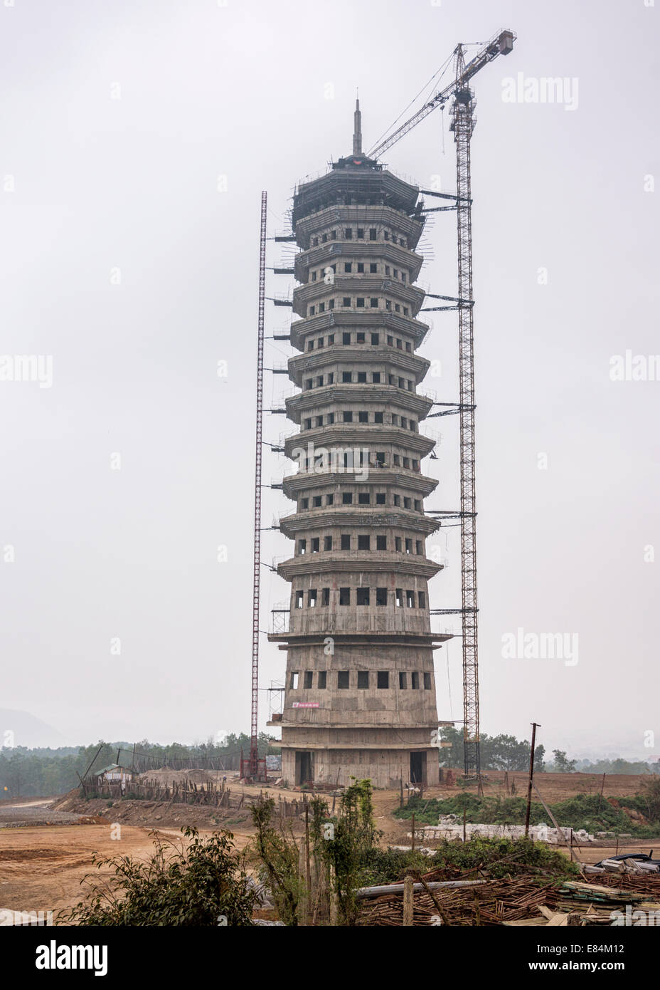 Thirteen stories high slender tower under construction with crane attached at the Pagoda. Stock Photo