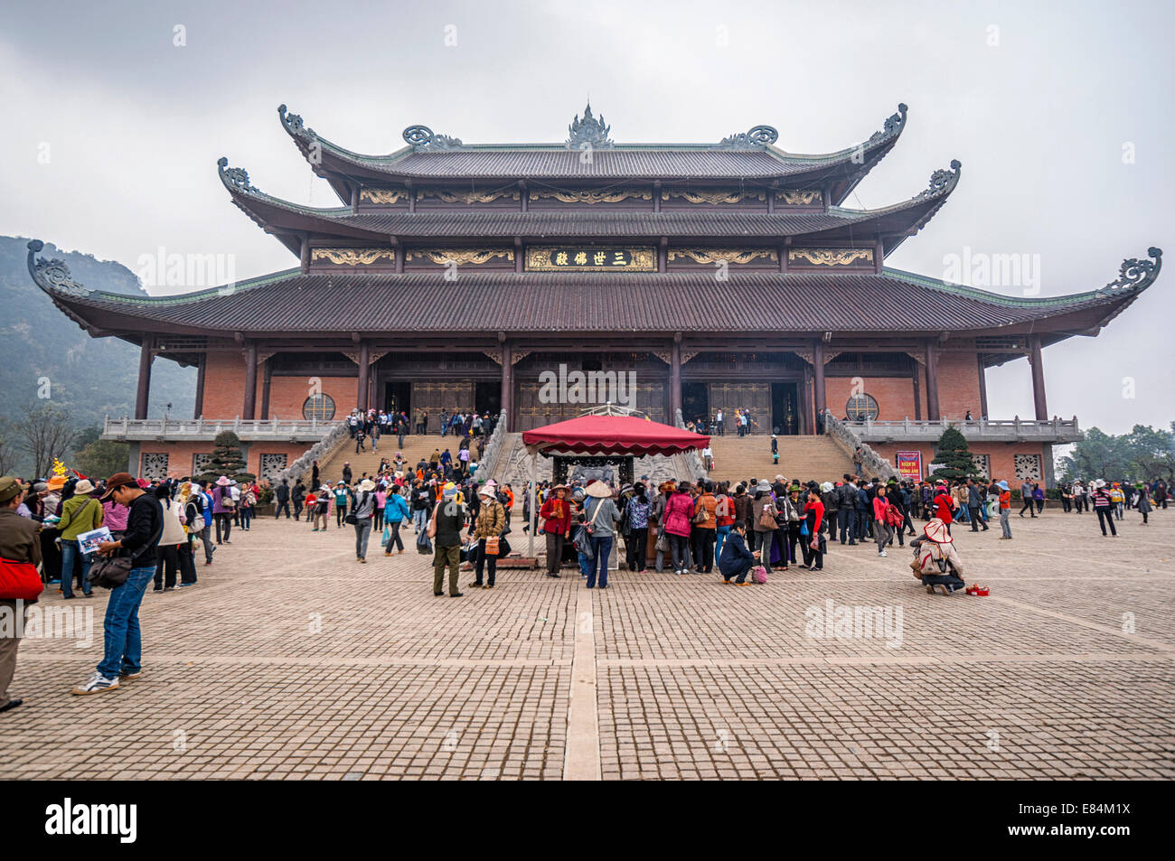 Chua Bai Dinh Buddhist Pagoda: wide square fronts large building holding giant Buddha. Stock Photo