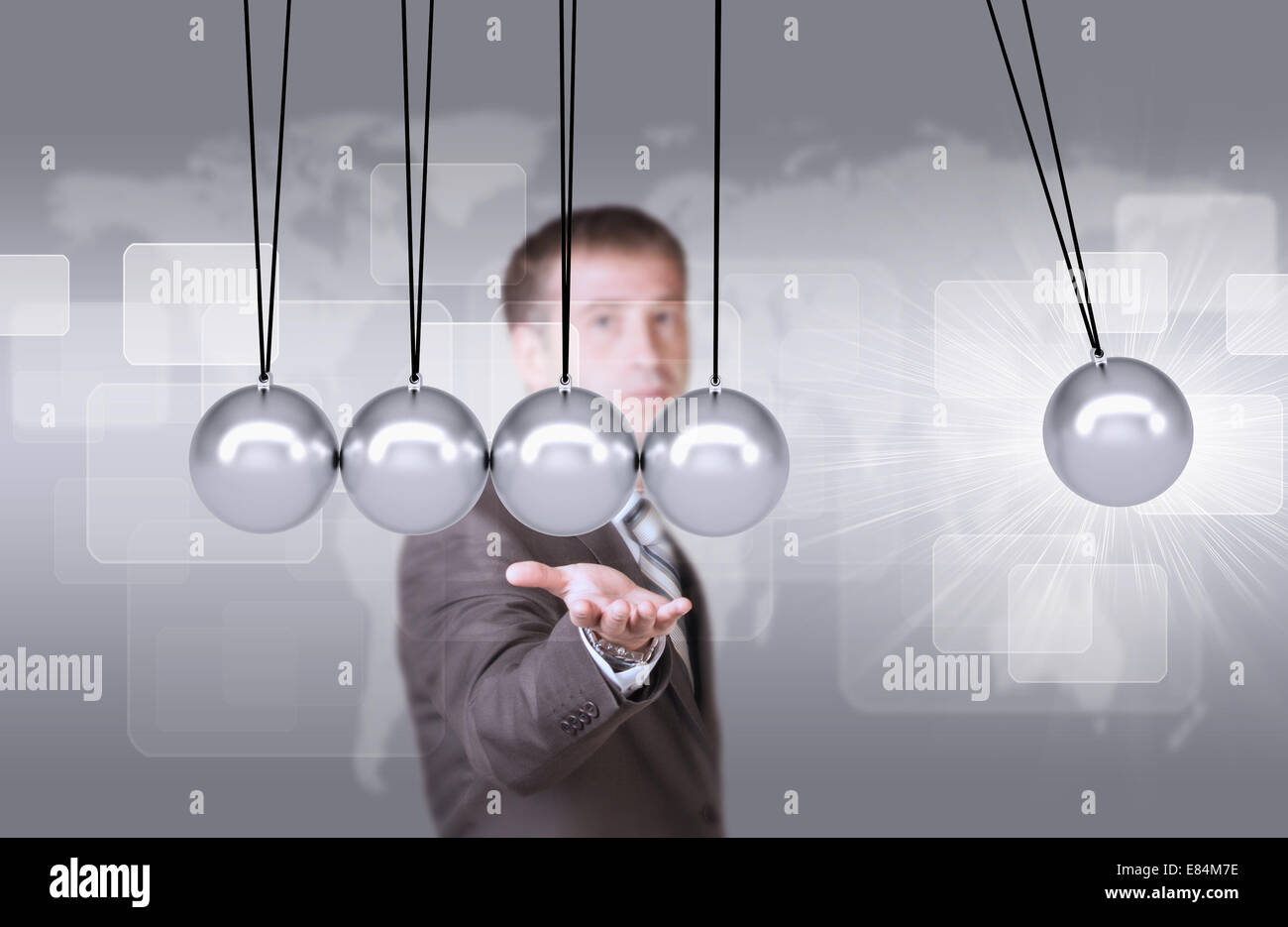Businessman in suit hold Newtons cradle Stock Photo