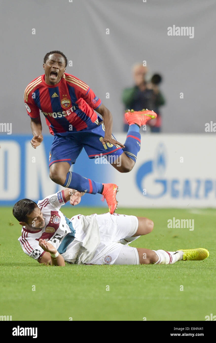 Moscow, Russia. 30th Sept, 2014.Mehdi Benatia (L) of Bayern Munich in action against Ahmed Musa of CSKA Moscow during the UEFA Champion League Group E soccer match between CSKA Moscow and Bayern Munich at Arena Khimki in Moscow, Russia, 30 September 2014. Credit:  dpa picture alliance/Alamy Live News Stock Photo