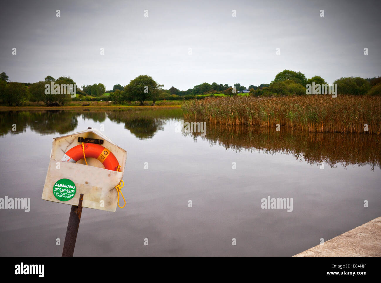 Lifebelt and sign for the Samaritans alongside a slipway into Lough MacNean, County Fermanagh, Northern Ireland Stock Photo