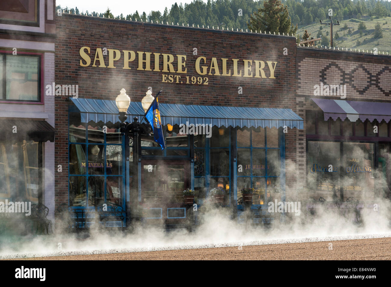 A Saturday morning in June was the time chosen to chip seal Philipsburg's main street, Broadway. Philipsburg, Montana. Stock Photo