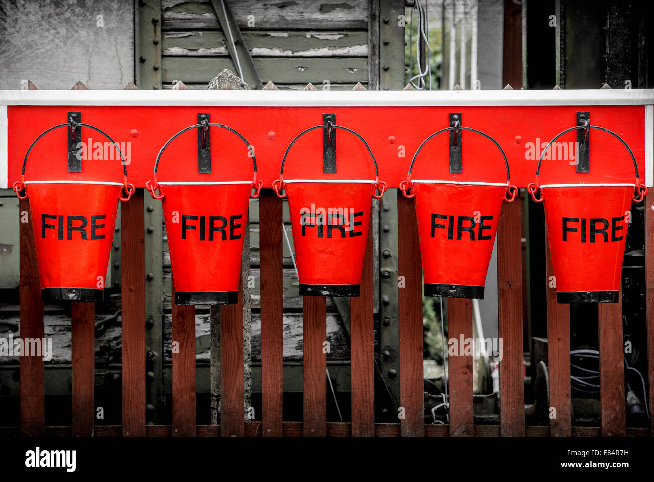 Five vintage firefighting buckets. Stock Photo