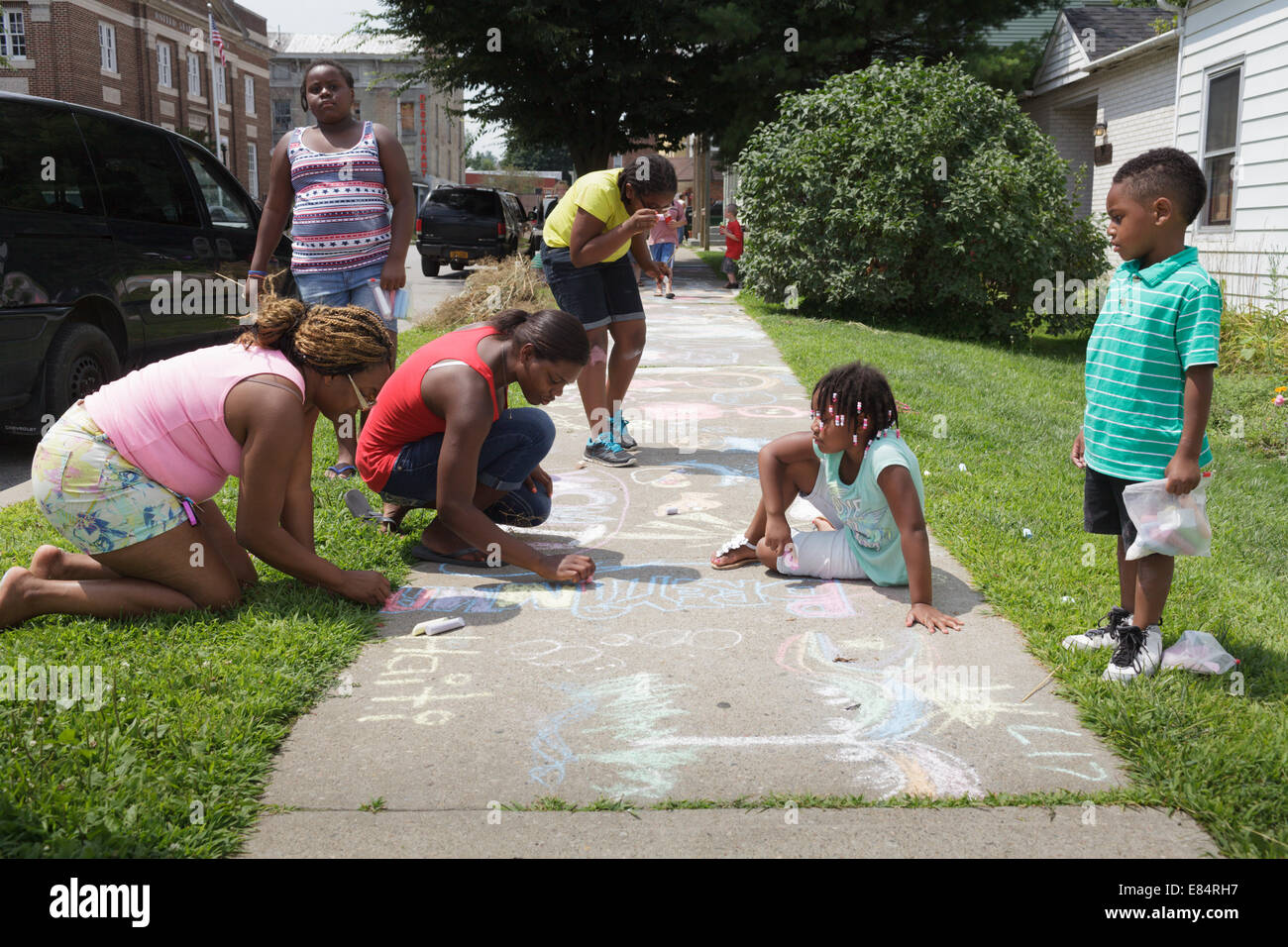 Family enjoys sidewalk chalk festival, Fort Plain, New York State. Stock Photo