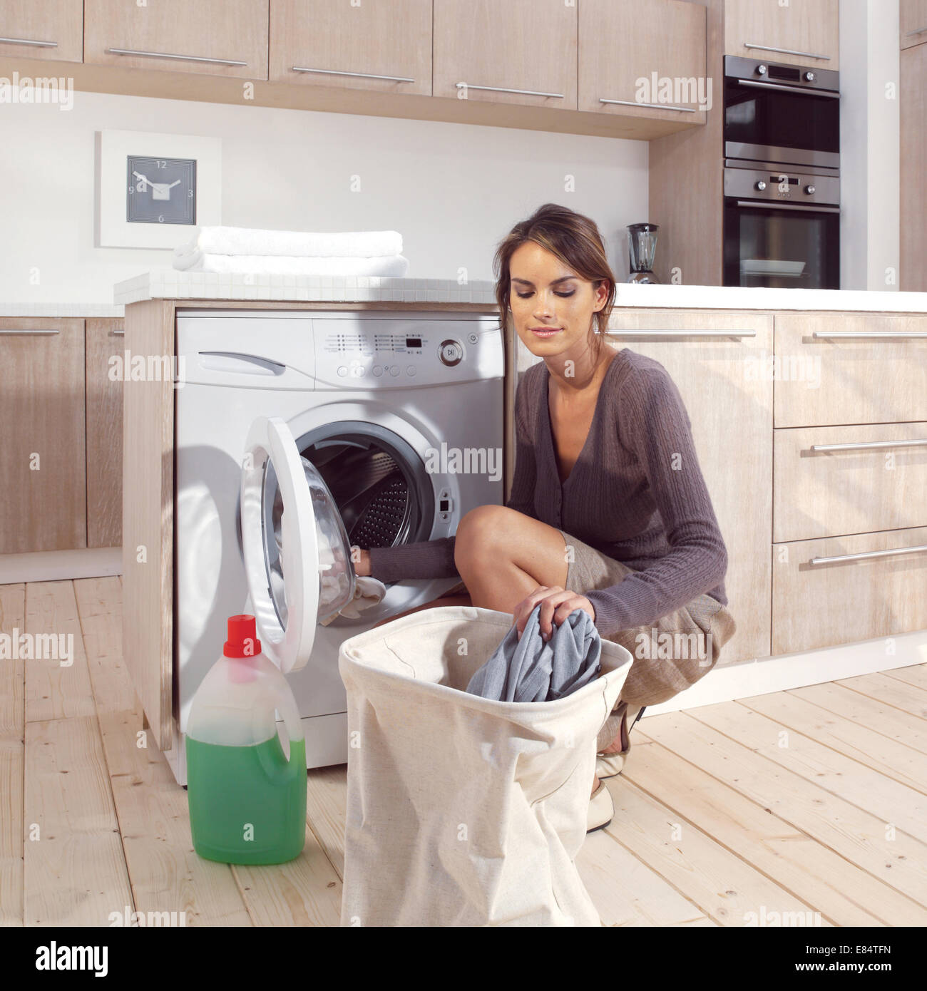 pretty smiling girl in the laundry room Stock Photo Alamy