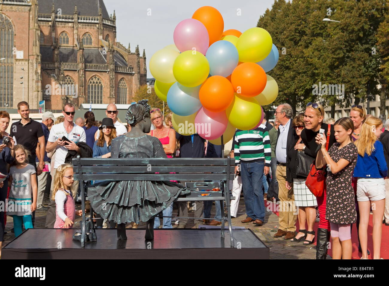 Arnhem, Netherlands - September 28, 2014: Girl with balloons on chair during the world championships living statues in Arnhem Stock Photo