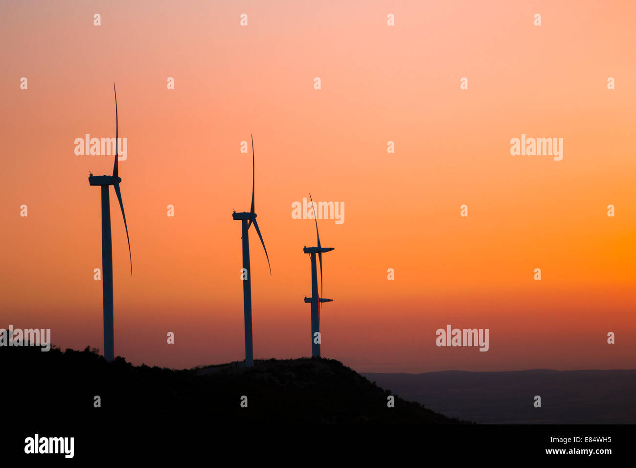 Wind turbines silhouette on the mountain during sunset Stock Photo - Alamy