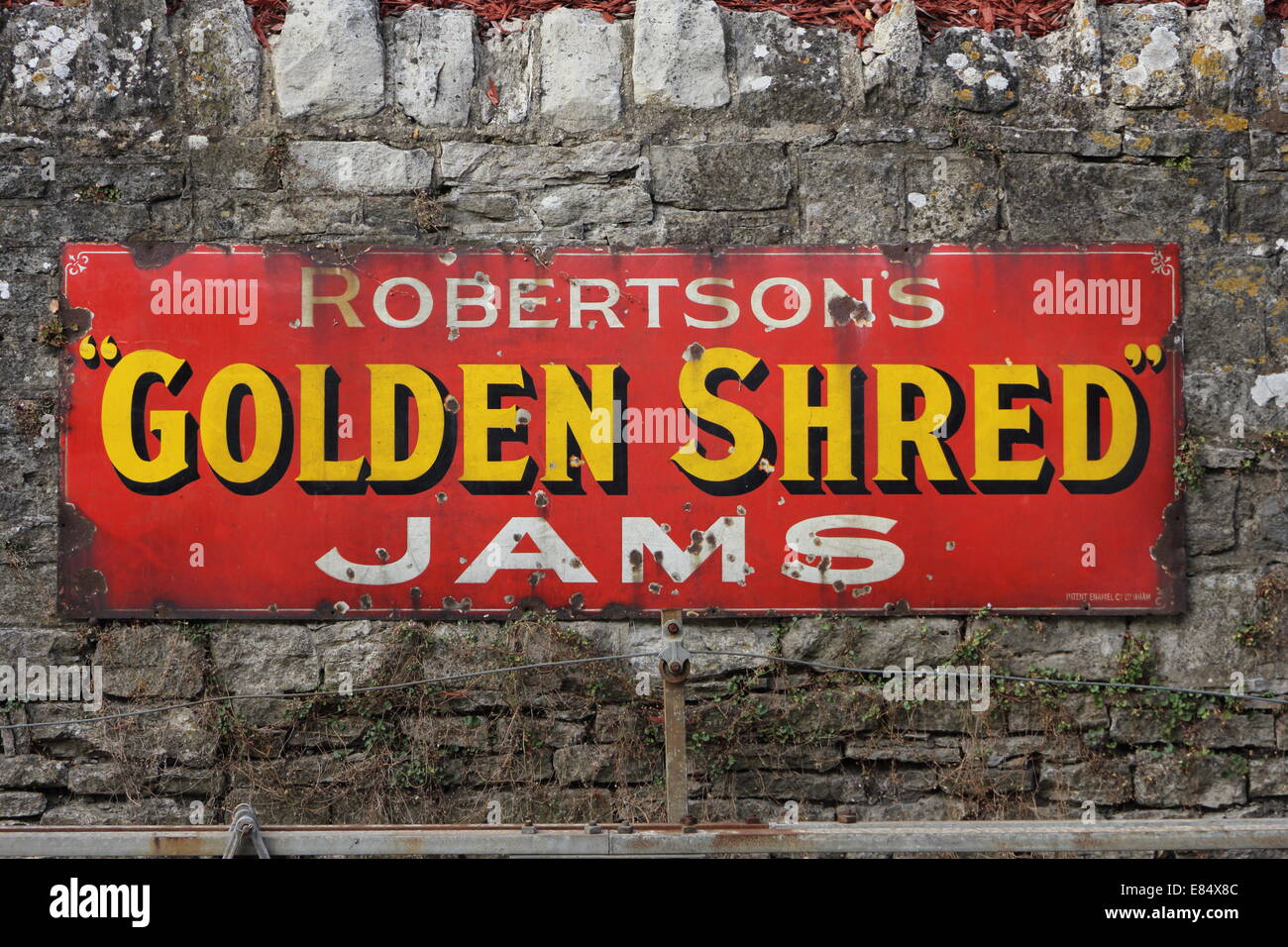 Old metal railway advertising board for Golden Shred Jam  with gold and white letters on a red background Stock Photo