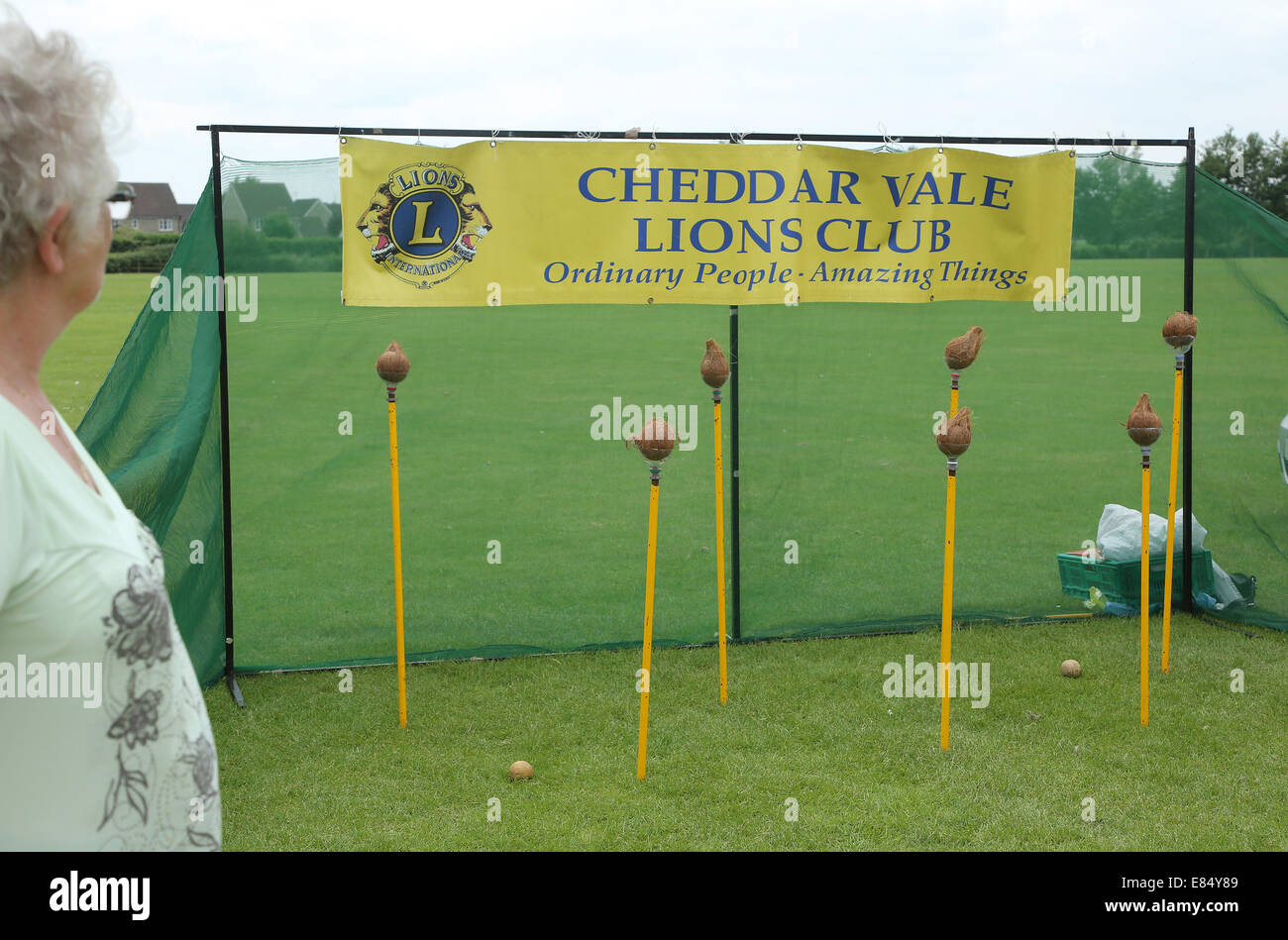 coconut shy run by Cheddar Vale Lions Club at a village fate on fathers day 2014 Stock Photo